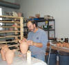 Jim waxing the lid seating area on a vase.