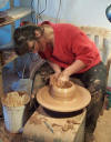 The next step in wheel throwing pottery is opening the clay body.