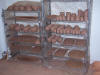 Green pots drying on drying racks.